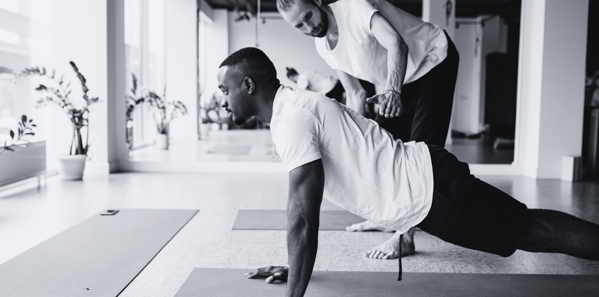 Black man doing yoga in a studio
