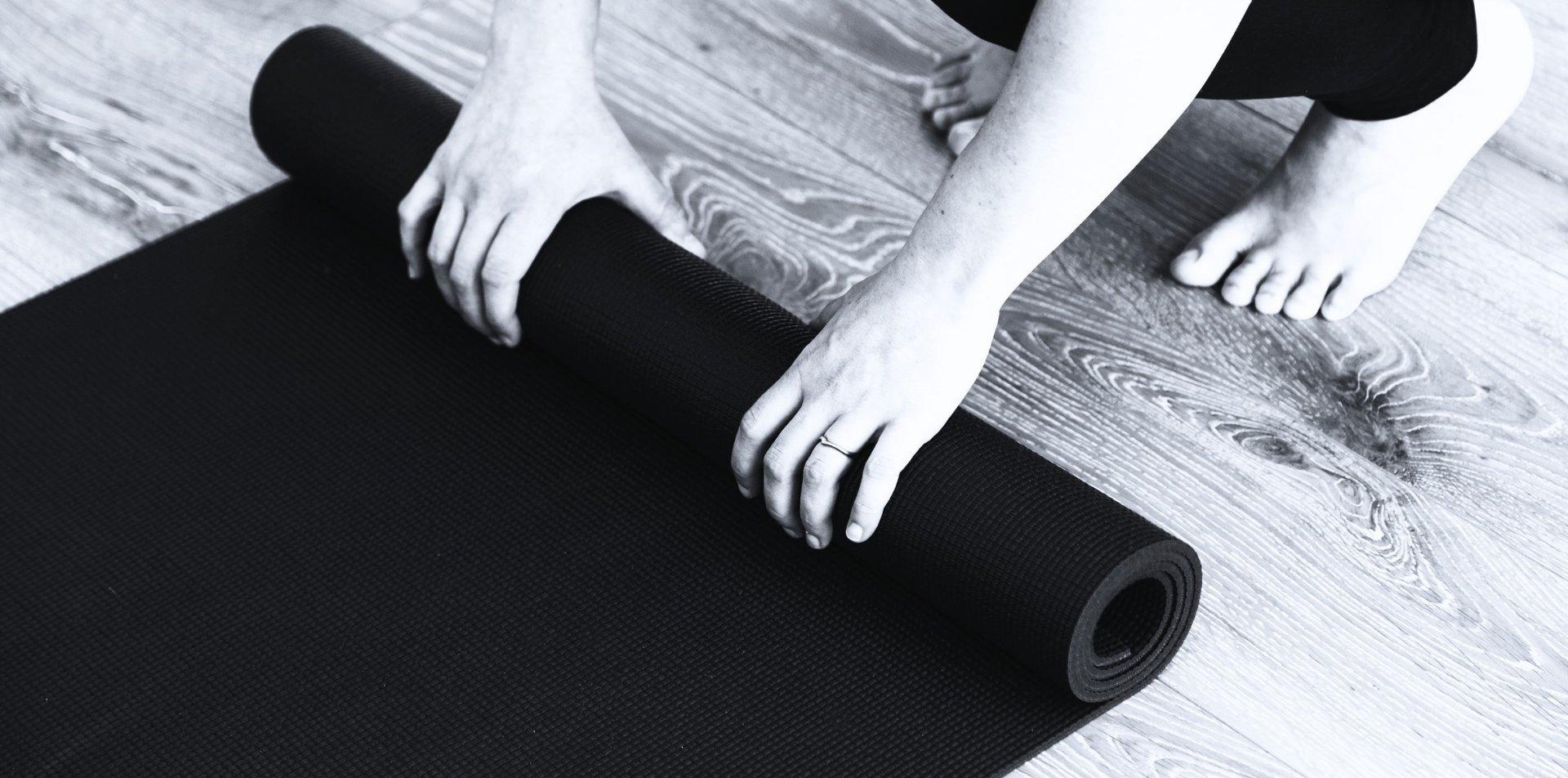Man unrolling a yoga mat